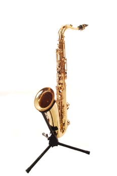 An brass saxophone on the stand.