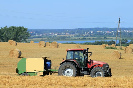Landscape with tractor and straw bales