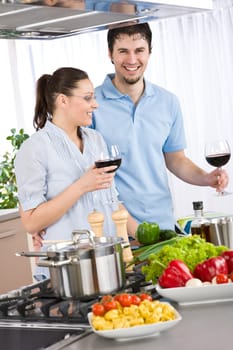 Cooking - happy couple together in modern kitchen