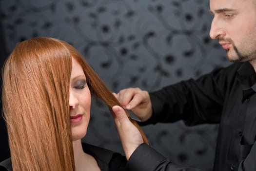 Professional hairdresser with fashion model at luxury salon