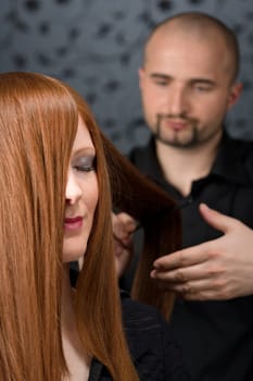 Professional hairdresser with fashion model at luxury salon