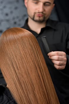 Professional hairdresser with fashion model at luxury salon