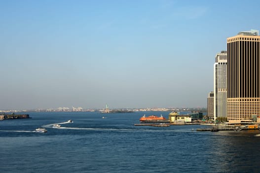 Walk across the East River at the southern tip of Manhattan towards the Statue of Liberty