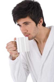 Young man in bathrobe with cup of coffee