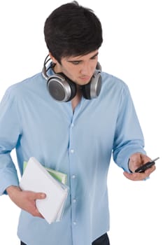 Male student sending text message holding books