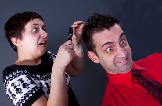 Woman examining mans hair