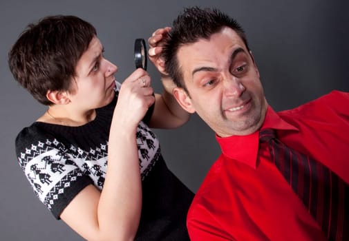 Woman examining mans hair