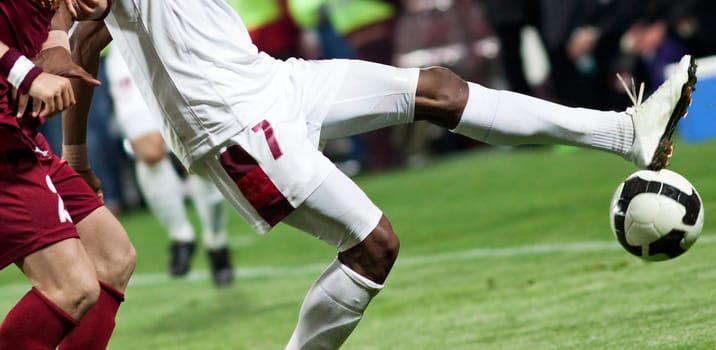 Soccer players fighting for the ball