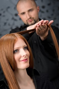 Professional hairdresser with fashion model at luxury salon