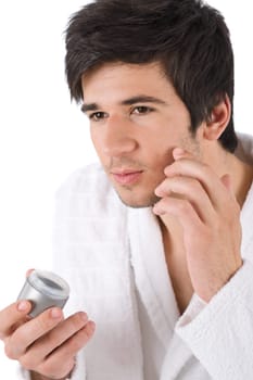 Facial care - Young man applying moisturizer