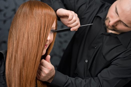 Professional hairdresser with fashion model at luxury salon