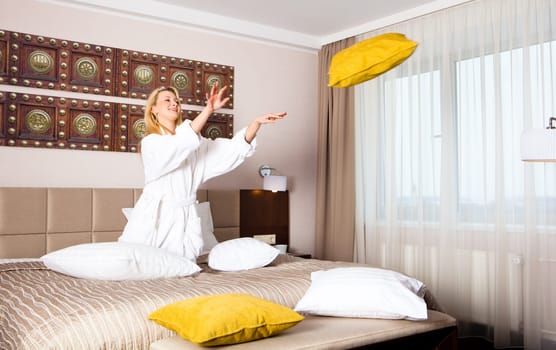 Woman Lying on Bed watching TV