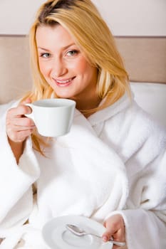 blond woman having morning coffee