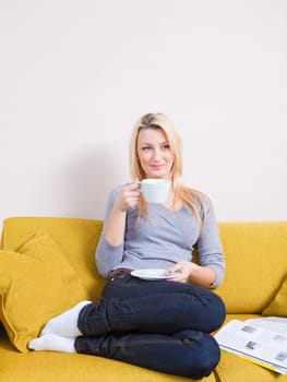 blond woman having morning coffee