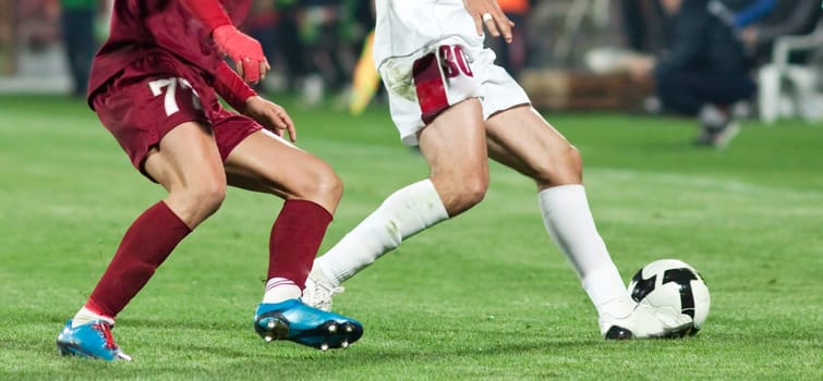 Soccer players fighting for the ball