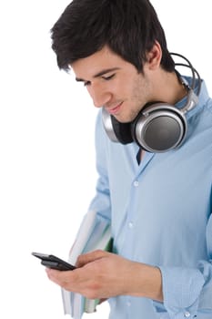 Male student sending text message holding books