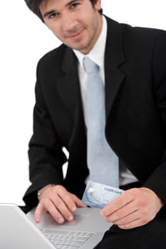Young businessman holding credit card