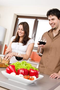 Cooking - happy couple together in modern kitchen