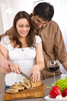 Cooking - happy couple together in modern kitchen