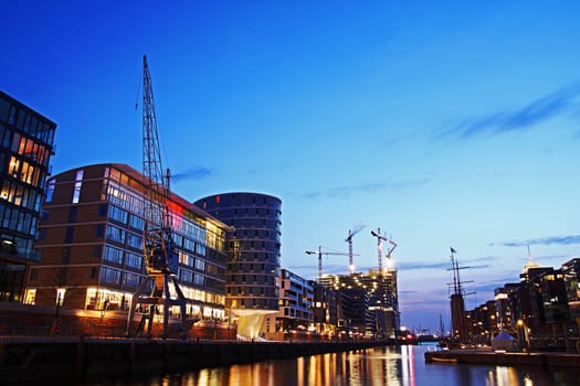Hamburg Hafencity in the evening (DRI) - View from the Magellan Terraces over the traditional ship harbour at Sandtorkai to the construction site of the Elbphilharmonie. Recorded on 07.04.2010.