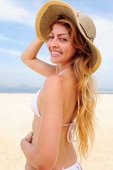 Summer on the beach Woman with straw hat