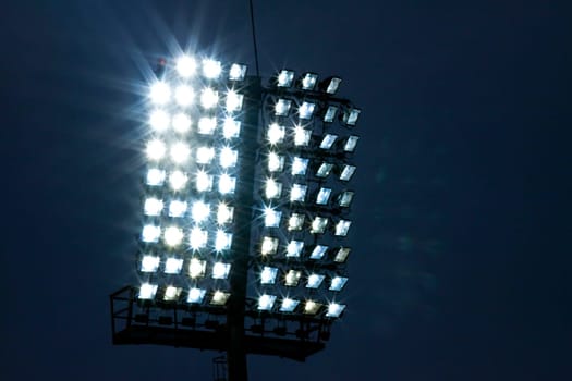 Stadium lights and dark blue sky