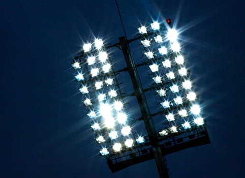 Stadium lights and dark blue sky