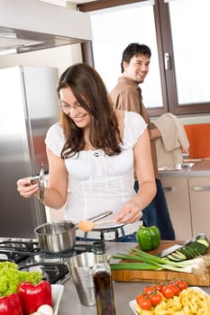 Cooking - happy couple together in modern kitchen