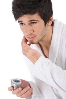 Facial care - man apply moisturizer