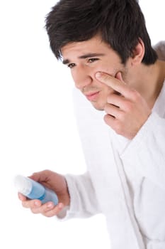 Facial care - Young man cleaning face with lotion