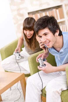 Students - happy teenagers playing video game