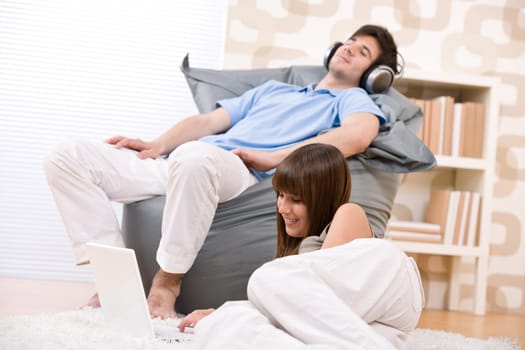 Student - Happy teenager with laptop relaxing