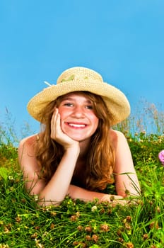 Young girl laying in meadow