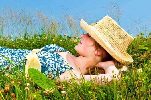Young girl resting in meadow