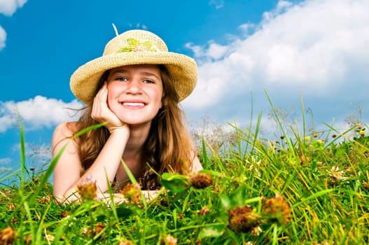 Young girl laying in meadow
