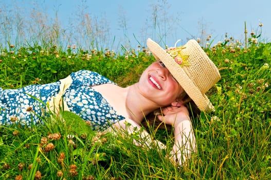 Young girl laying on meadow