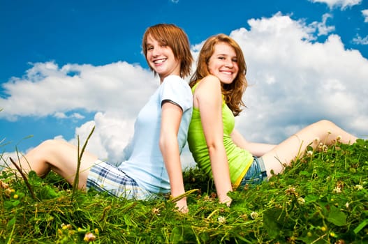 Young girls sitting in meadow