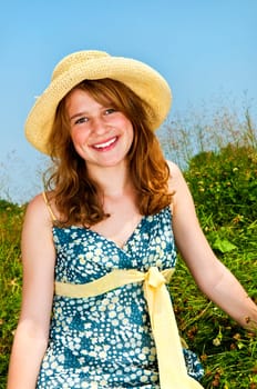 Young girl sitting in meadow