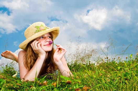 Young girl laying in meadow