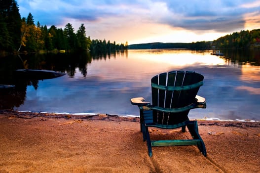 Wooden chair at sunset on beach