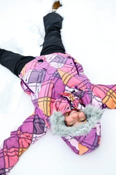 Girl making snow angel
