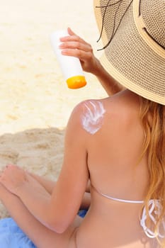 Woman applying sunscreen to herself