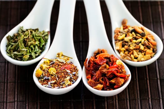 Assorted herbal wellness dry tea in spoons