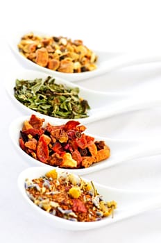 Assorted herbal wellness dry tea in spoons