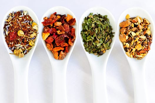 Assorted herbal wellness dry tea in spoons