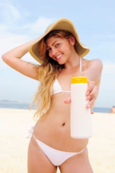 Woman with sunscreen on the beach