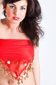Beautiful young woman covering her face and body in red oriental