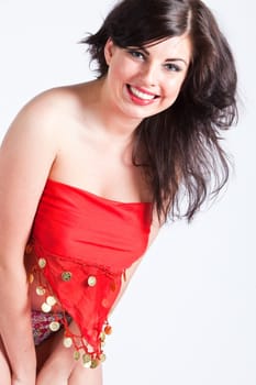Beautiful young woman covering her face and body in red oriental