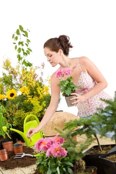 Gardening - smiling woman holding flower pot