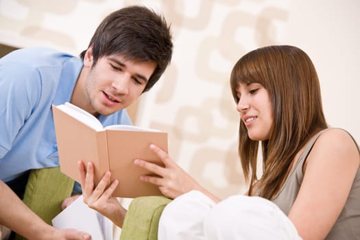 Student - two teenager reading book in lounge